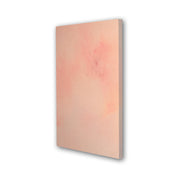 The side of a subtle abstract painting with acrylic washes of salmon pink and orange.