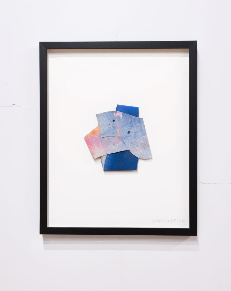 folded canvas painting inside a black frame