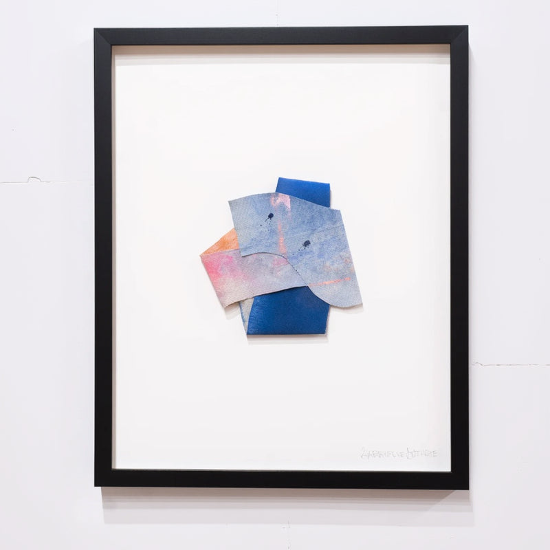 folded canvas painting inside a black frame