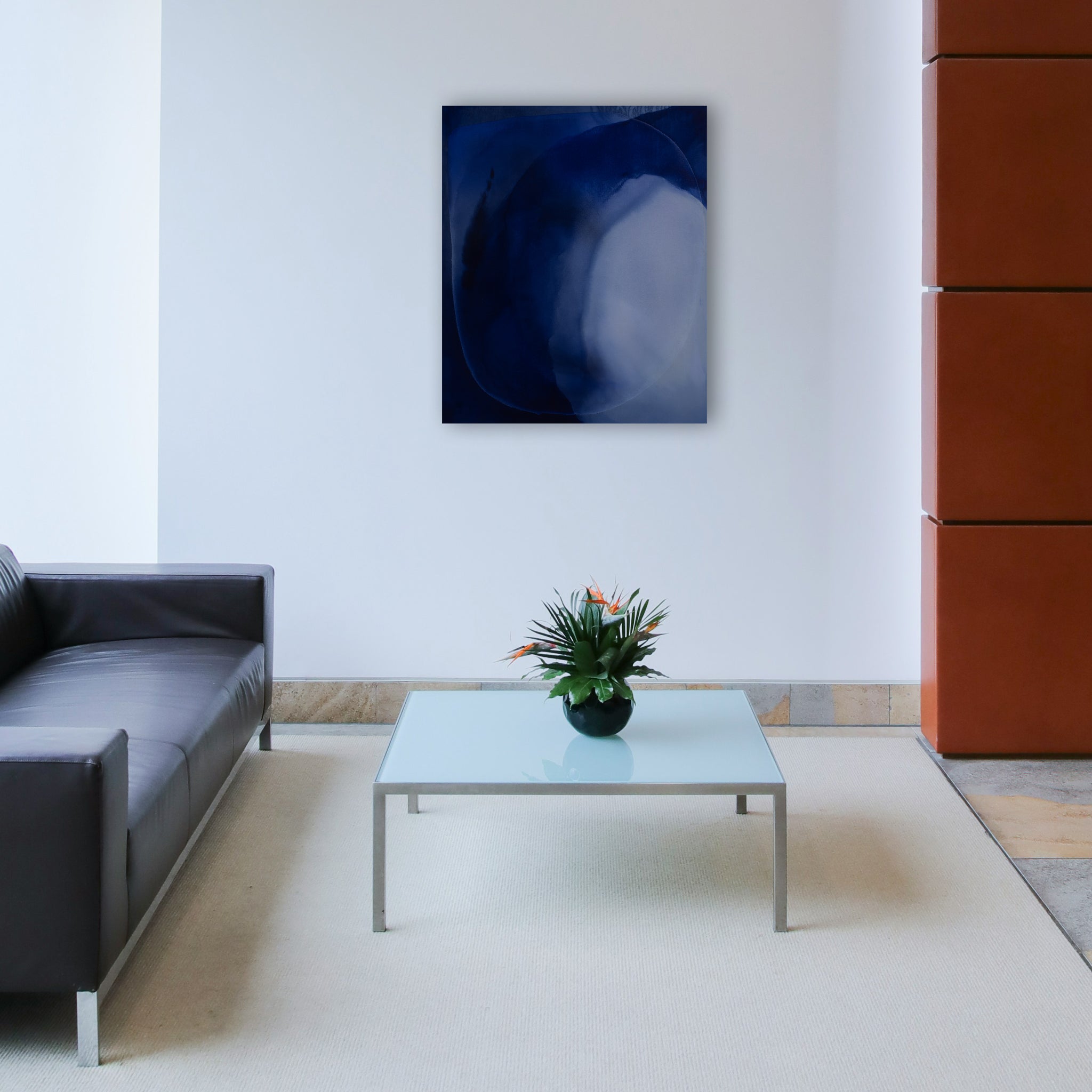 A dark and light blue painting hangs in a corporate lobby