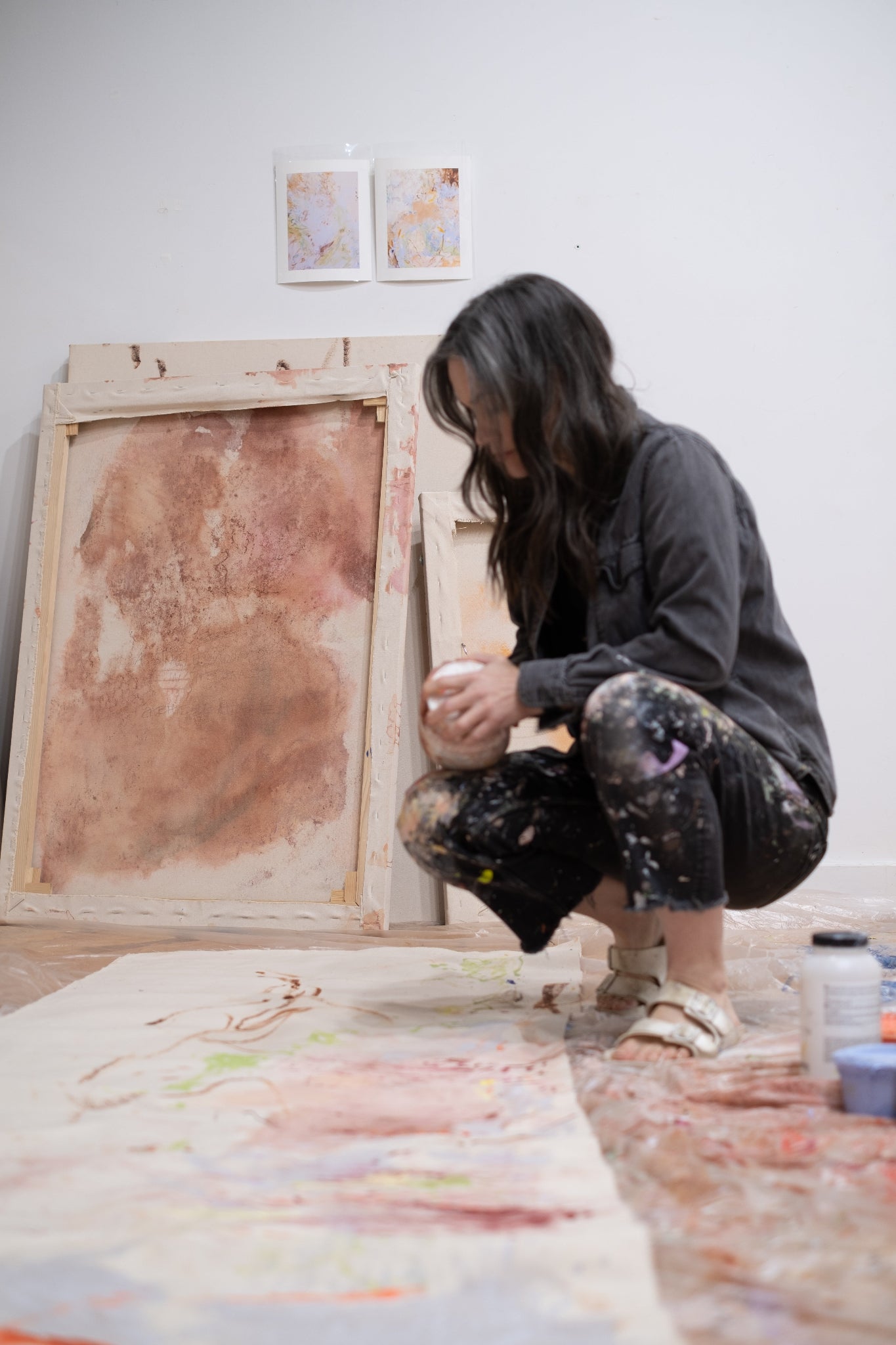 Person working on a painting in an art studio